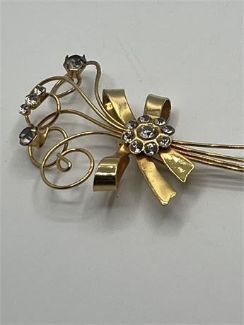 Gold tone flower bouquet with rhinestone center and petals