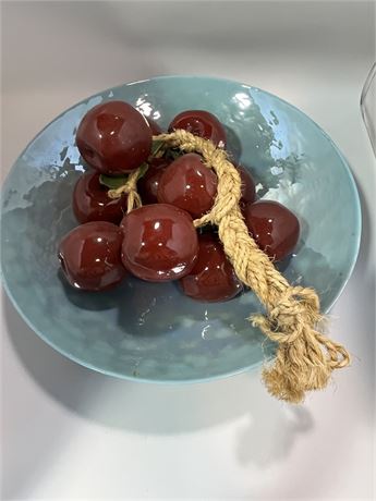 Large turquoise enamel bowl with red glass apples