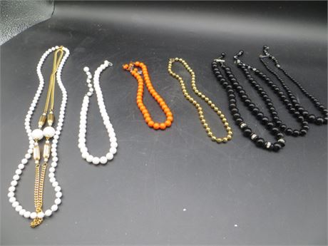 VINTAGE NECKLACES 2 WHITE,1 ORANGE, 1 GOLD TONE & 3 BLACK