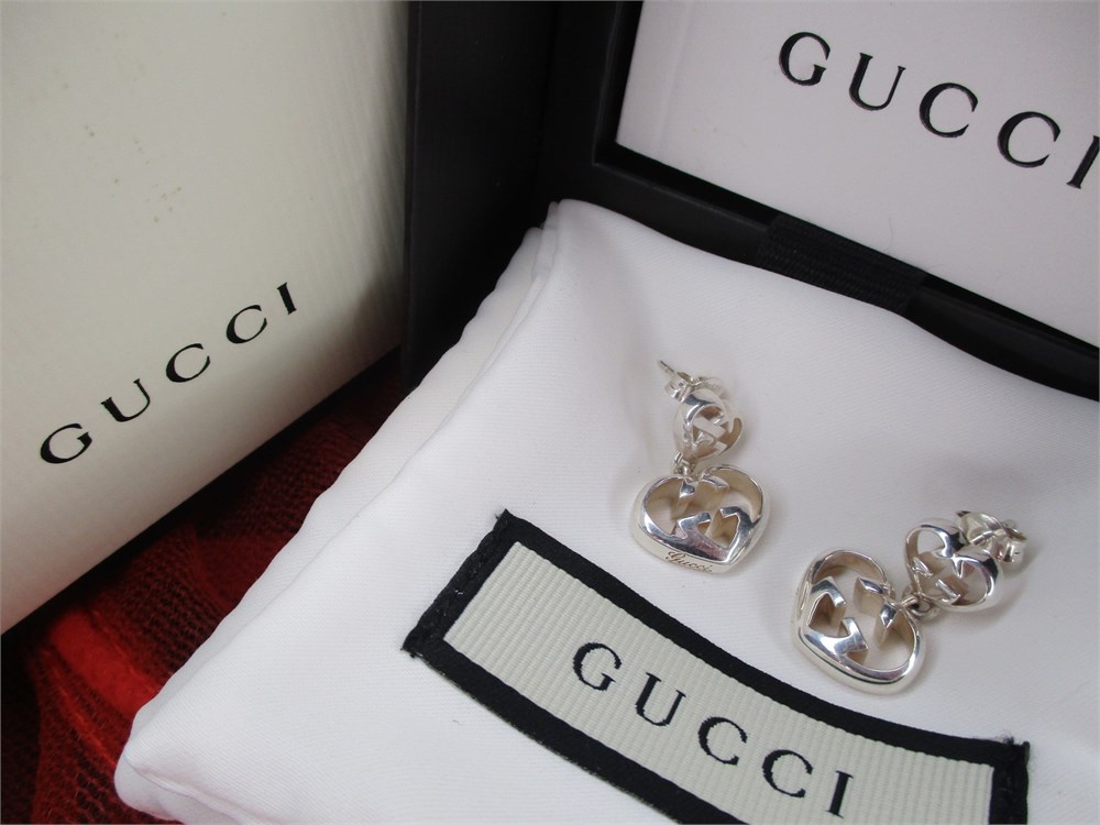 Sold at Auction: A pair of ladies Gucci earrings with pouch.
