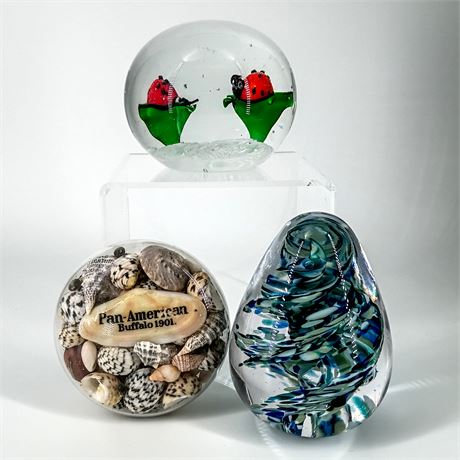 Trio of Decorative Art Glass Paperweights – Ladybugs, Seashells, and Blue Swirl