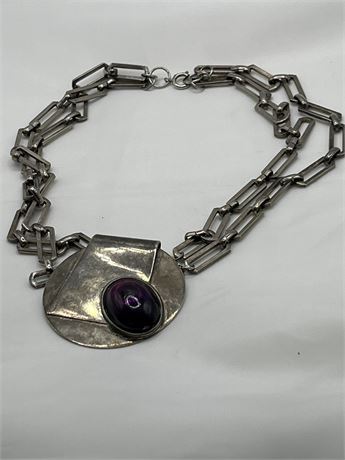 Moderate silver necklace with purple stone