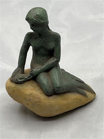6 1/2 inch tall, nude, resin mermaid souvenir on a rock