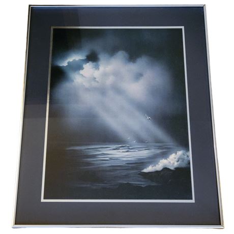 Sun Peaking Through the Clouds Over the Ocean Framed Print